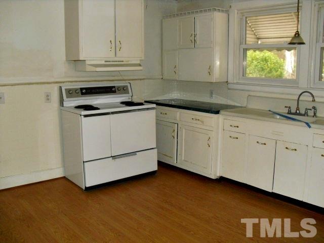 2509 Ross Road Durham, NC 27703 - Photo 17 of 24 a kitchen with granite countertop white cabinets and a sink