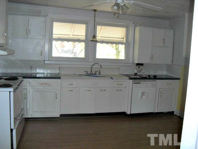 2509 Ross Road Durham, NC 27703 - Photo 18 of 24 a kitchen with granite countertop white cabinets and a sink