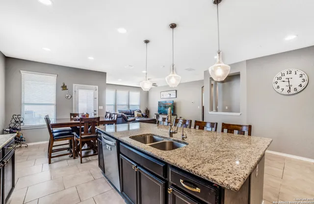 a kitchen with center island table and chairs