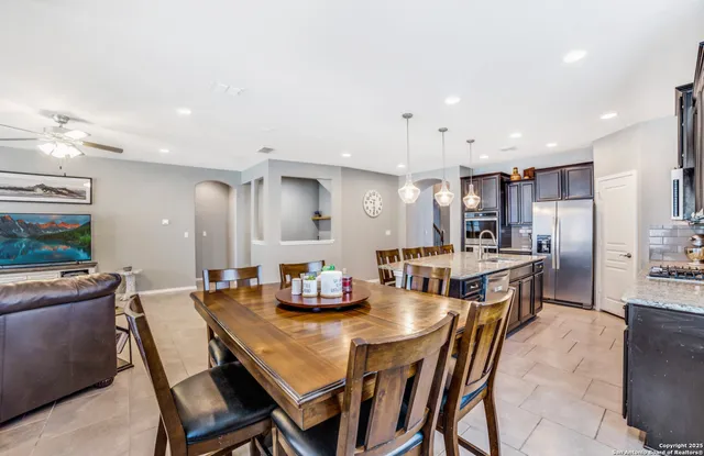 a large kitchen with a table and chairs