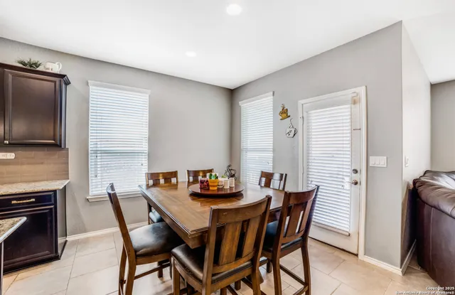 a dining room with furniture and window