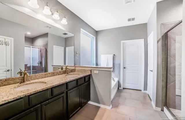 a bathroom with a double vanity sink and a mirror