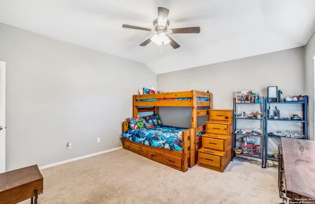 a bedroom with furniture and lamp