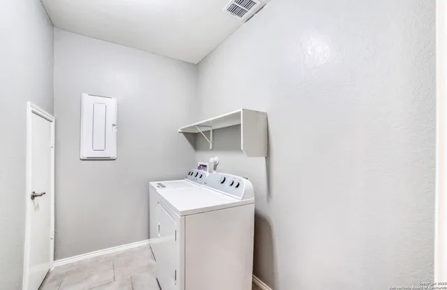 a utility room with sink dryer and washer
