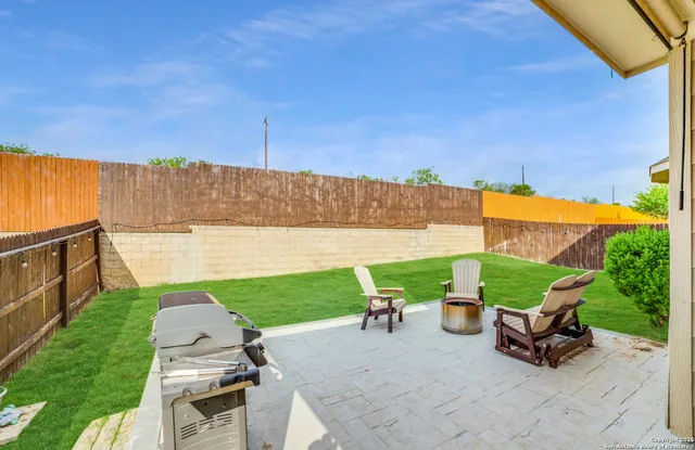 a view of a backyard with sitting area