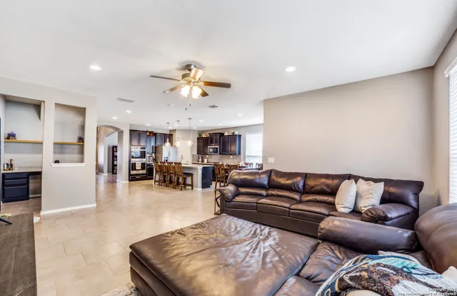 a living room with furniture and kitchen view