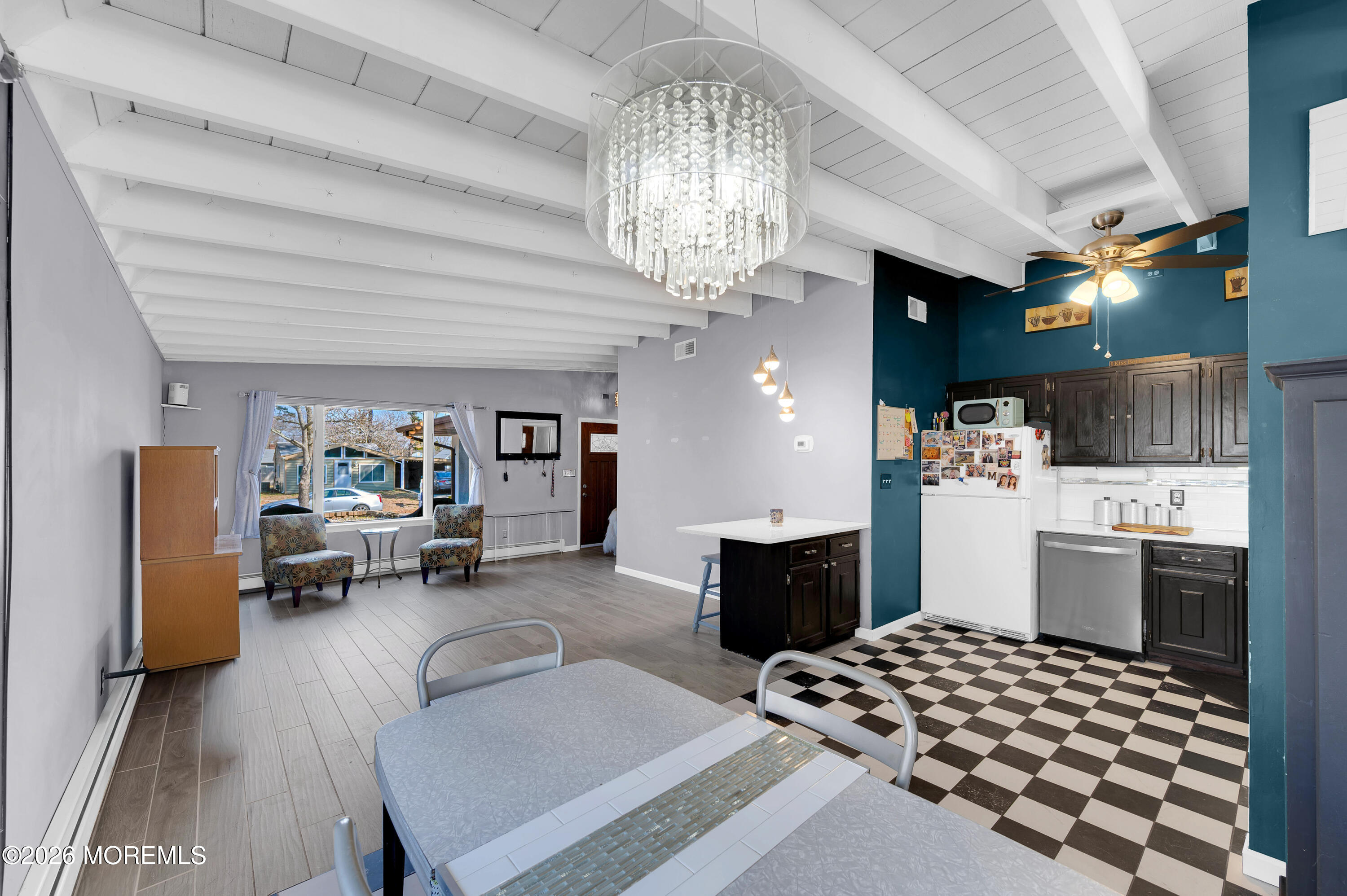 715 Tampa Road Forked River, NJ 08731 - Photo 13 of 44 a kitchen with a sink stainless steel appliances a dining table and chairs