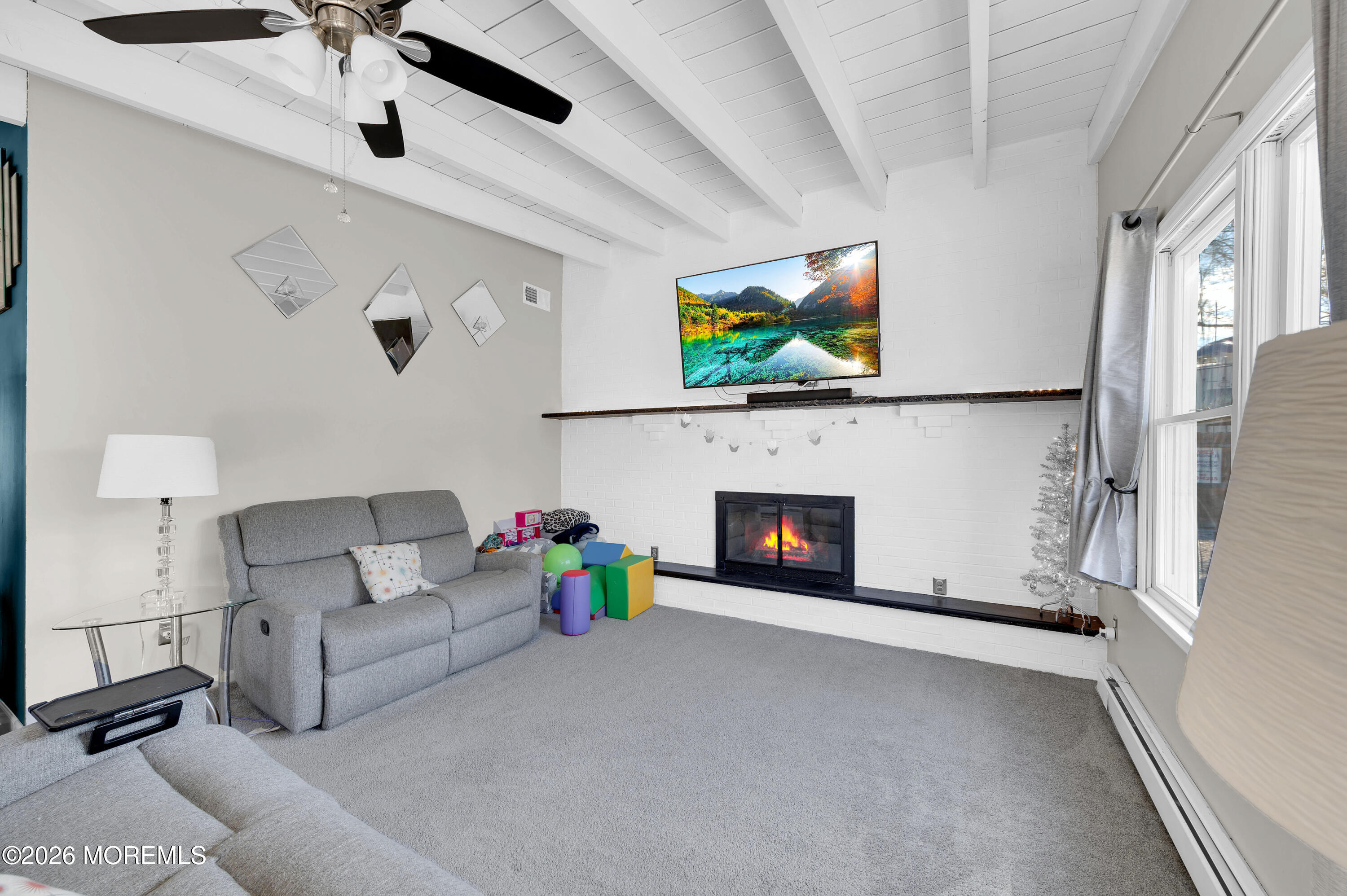 715 Tampa Road Forked River, NJ 08731 - Photo 16 of 44 a living room with furniture and a fireplace