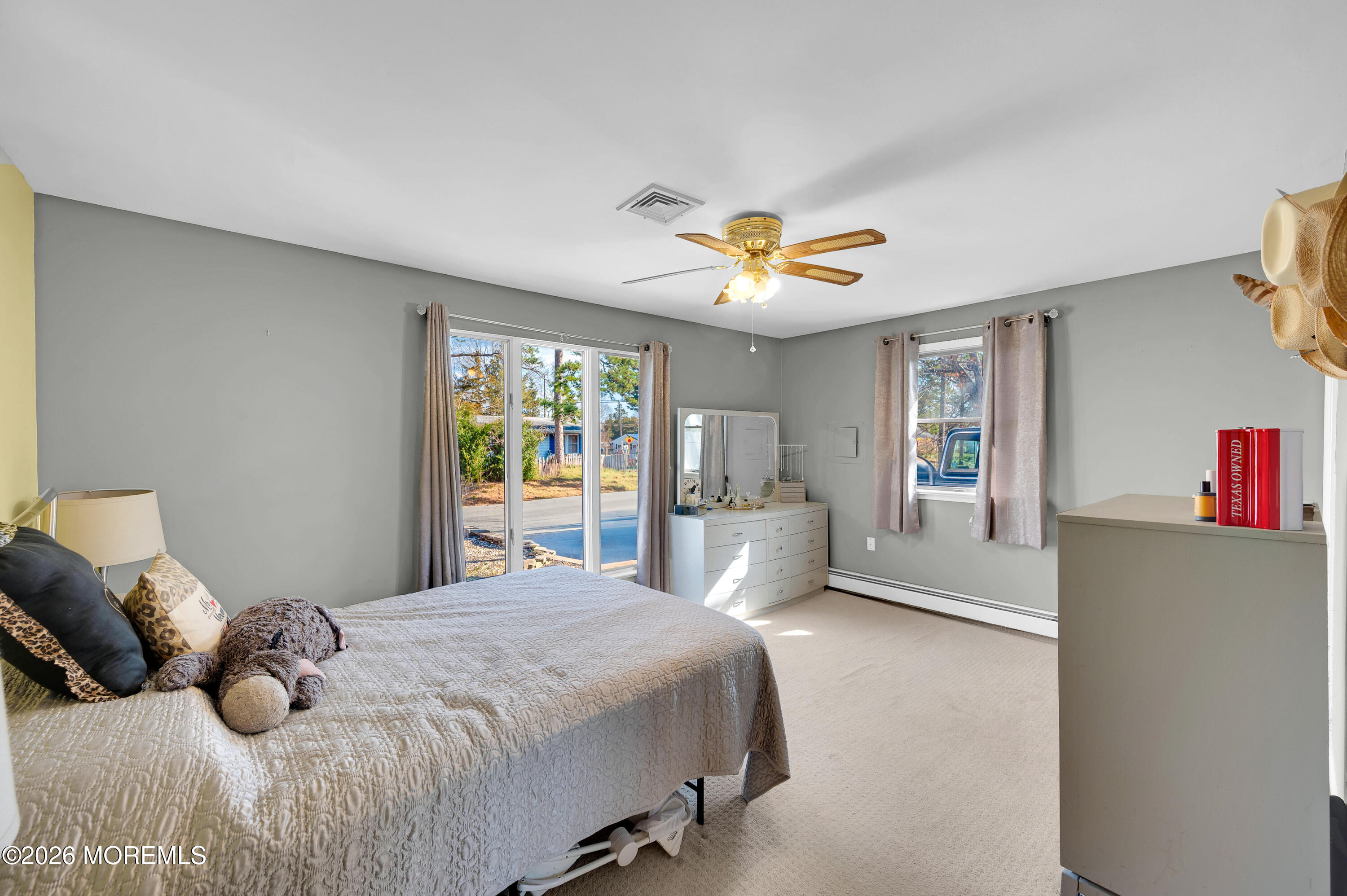 715 Tampa Road Forked River, NJ 08731 - Photo 21 of 44 a bedroom with a large bed and a chandelier
