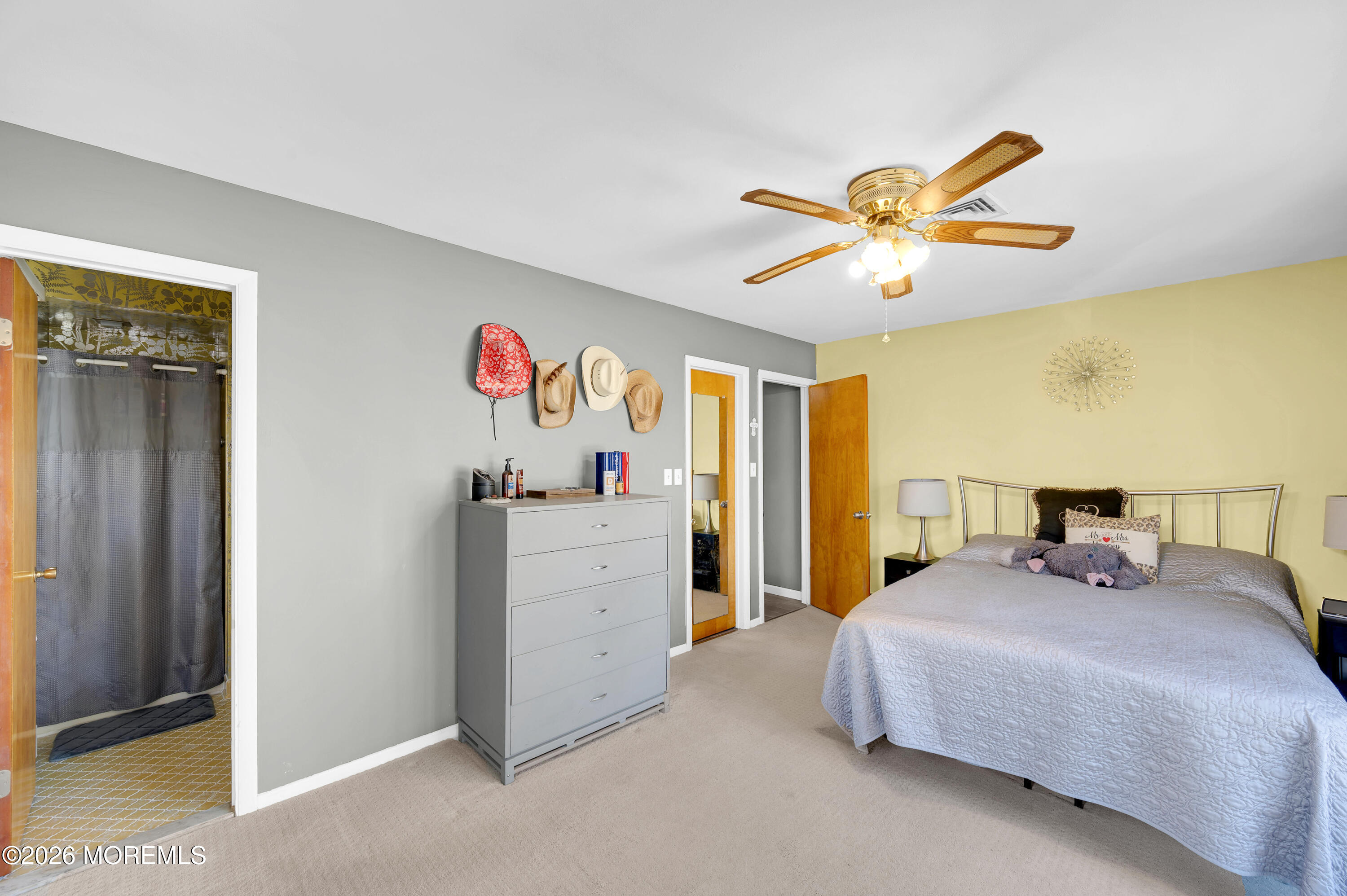 715 Tampa Road Forked River, NJ 08731 - Photo 22 of 44 a bedroom with a bed and a chandelier