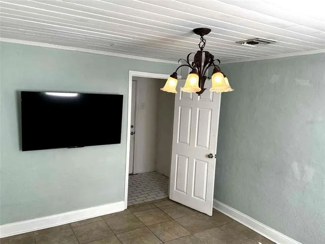 a view of a hallway to front door and wooden floor