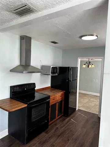 a kitchen with stainless steel appliances granite countertop a stove a refrigerator and a microwave
