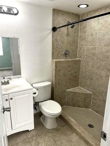 a bathroom with a sink toilet and shower