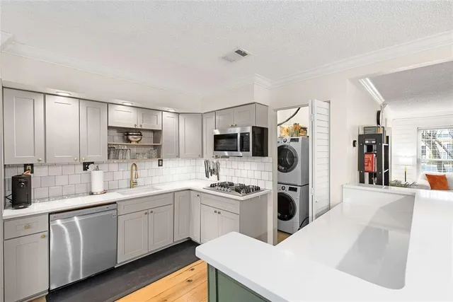 a kitchen with cabinets a sink and appliances