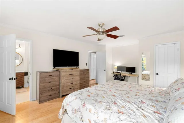 a bed room with a television and a mirror