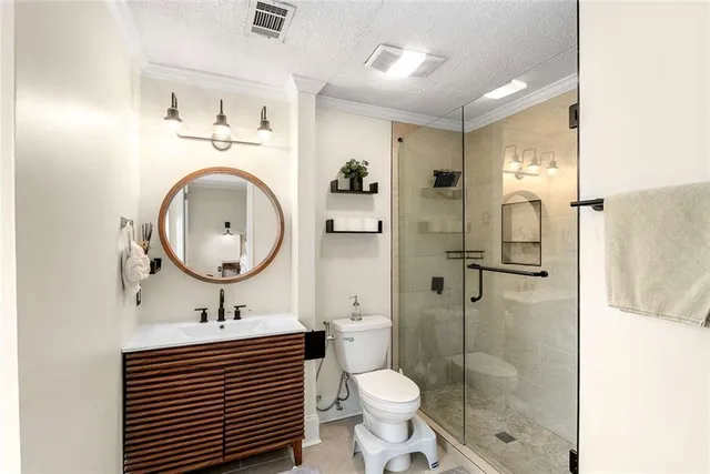 a bathroom with a sink a toilet and shower