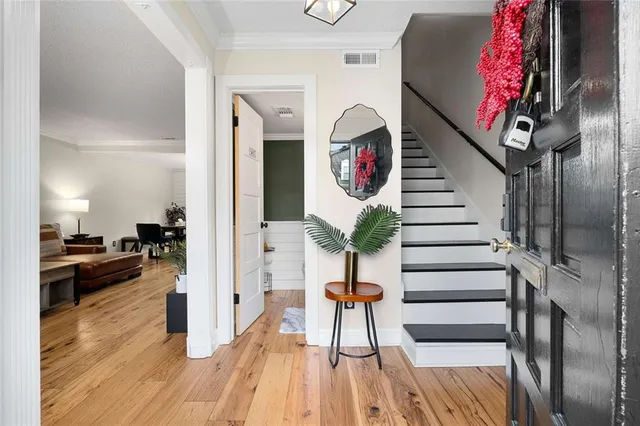 a view of entryway and hall with wooden floor