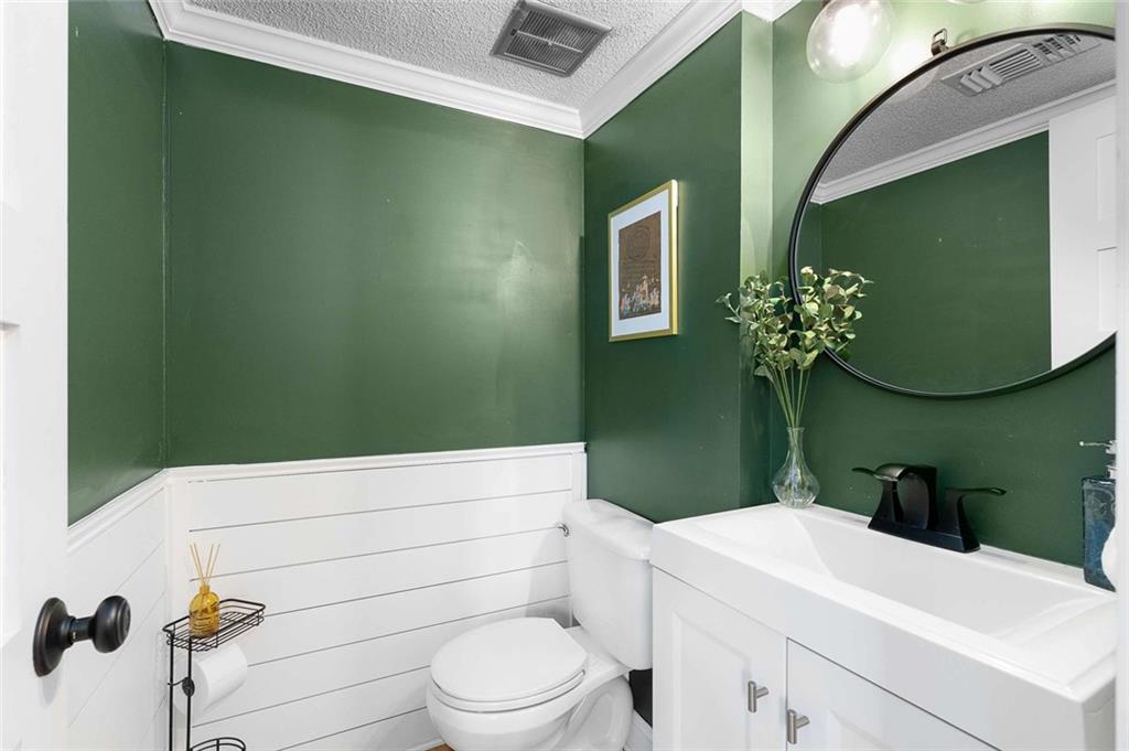 5 Spinning House Place Northwest Atlanta, GA 30318 - Photo 4 of 42 a bathroom with a toilet sink and mirror