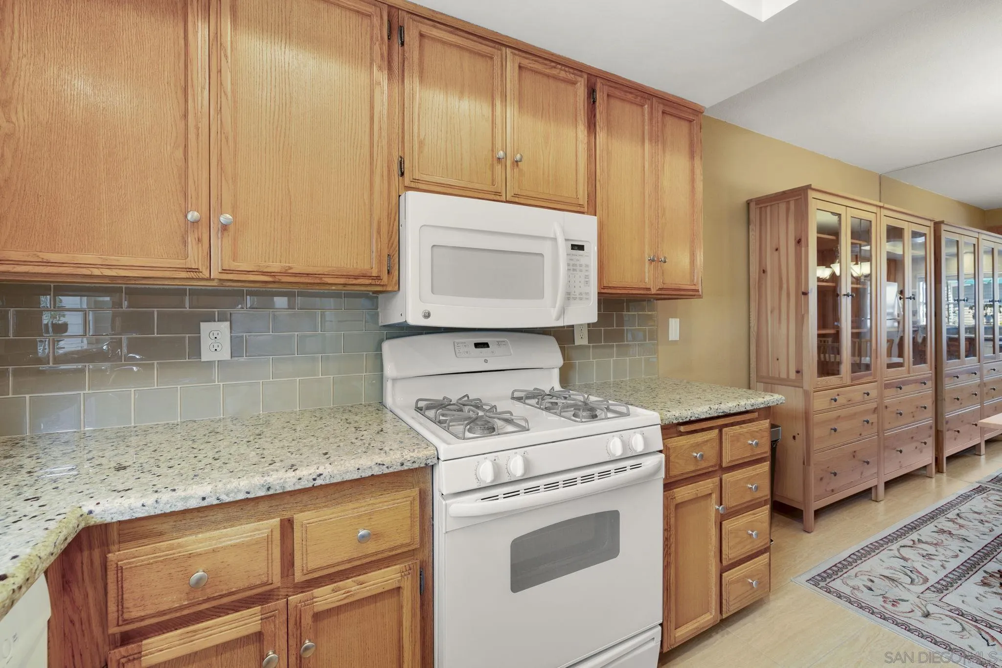 677 Summer View Circle Encinitas, CA 92024 - Photo 11 of 58 a kitchen with stainless steel appliances granite countertop a sink stove and cabinets