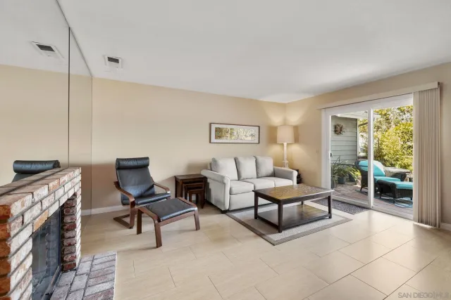 a living room with furniture flat screen tv and a fireplace