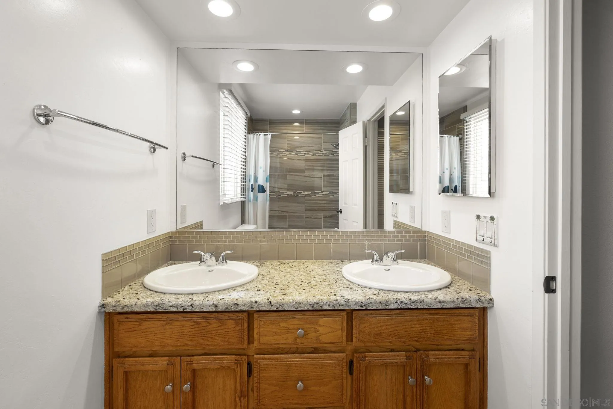677 Summer View Circle Encinitas, CA 92024 - Photo 23 of 58 a bathroom with a granite countertop sink a mirror and a shower