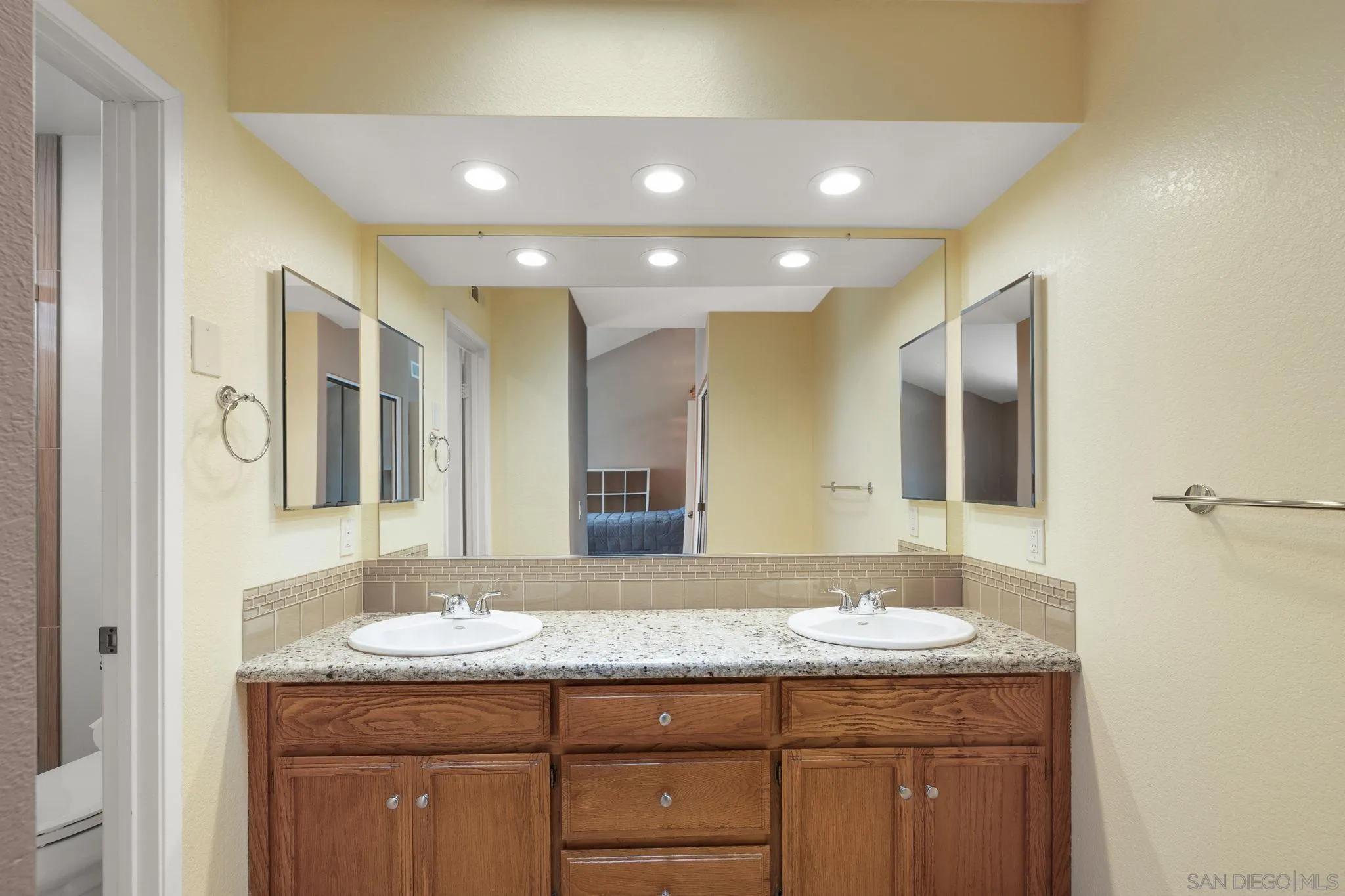 677 Summer View Circle Encinitas, CA 92024 - Photo 28 of 58 a bathroom with a granite countertop sink and a mirror