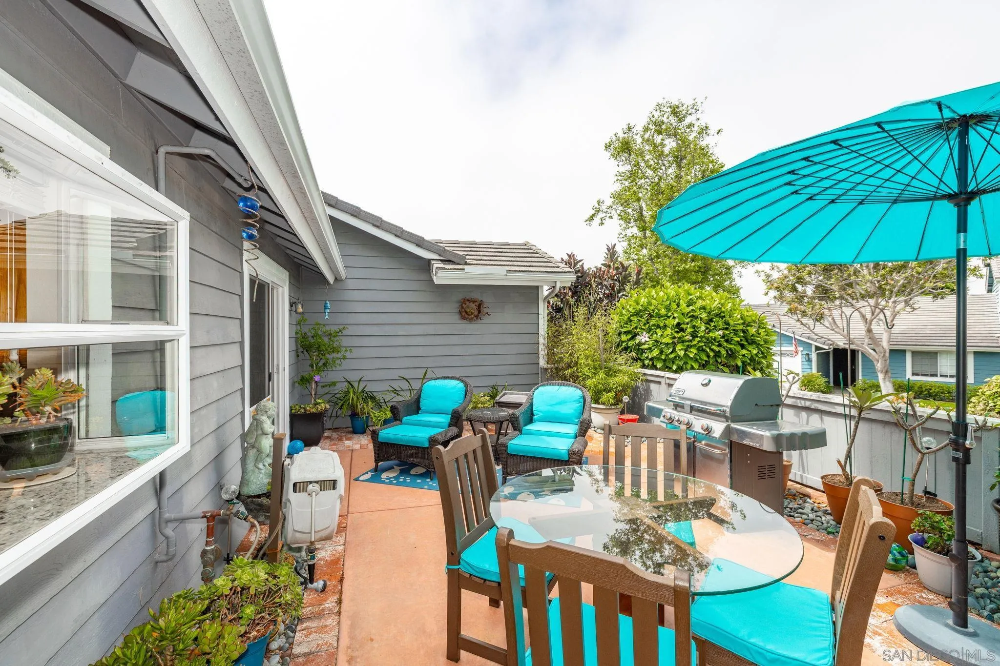 677 Summer View Circle Encinitas, CA 92024 - Photo 31 of 58 a view of a patio with table and chairs under an umbrella