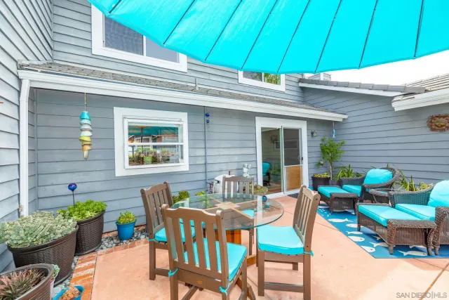 a view of a chairs and table in patio