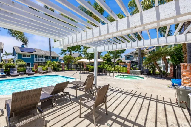 a swimming pool with outdoor seating and yard