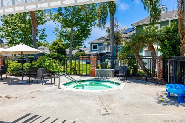 a front view of a house with swimming pool garden and patio