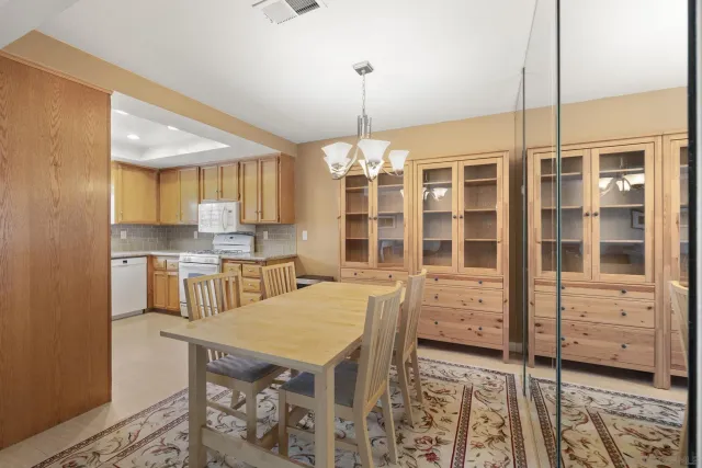 a kitchen with stainless steel appliances granite countertop a stove a sink and a white cabinets
