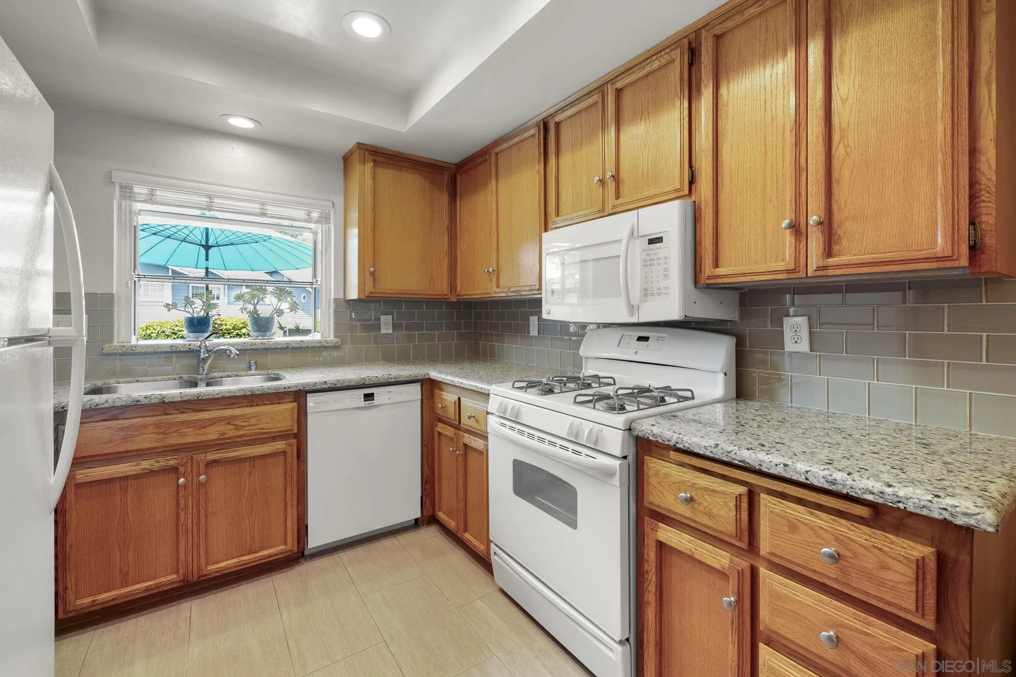 677 Summer View Circle Encinitas, CA 92024 - Photo 8 of 58 a kitchen with stainless steel appliances granite countertop a stove a sink and a white cabinets
