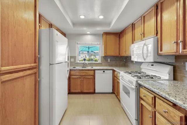 a kitchen with stainless steel appliances granite countertop a sink stove and cabinets