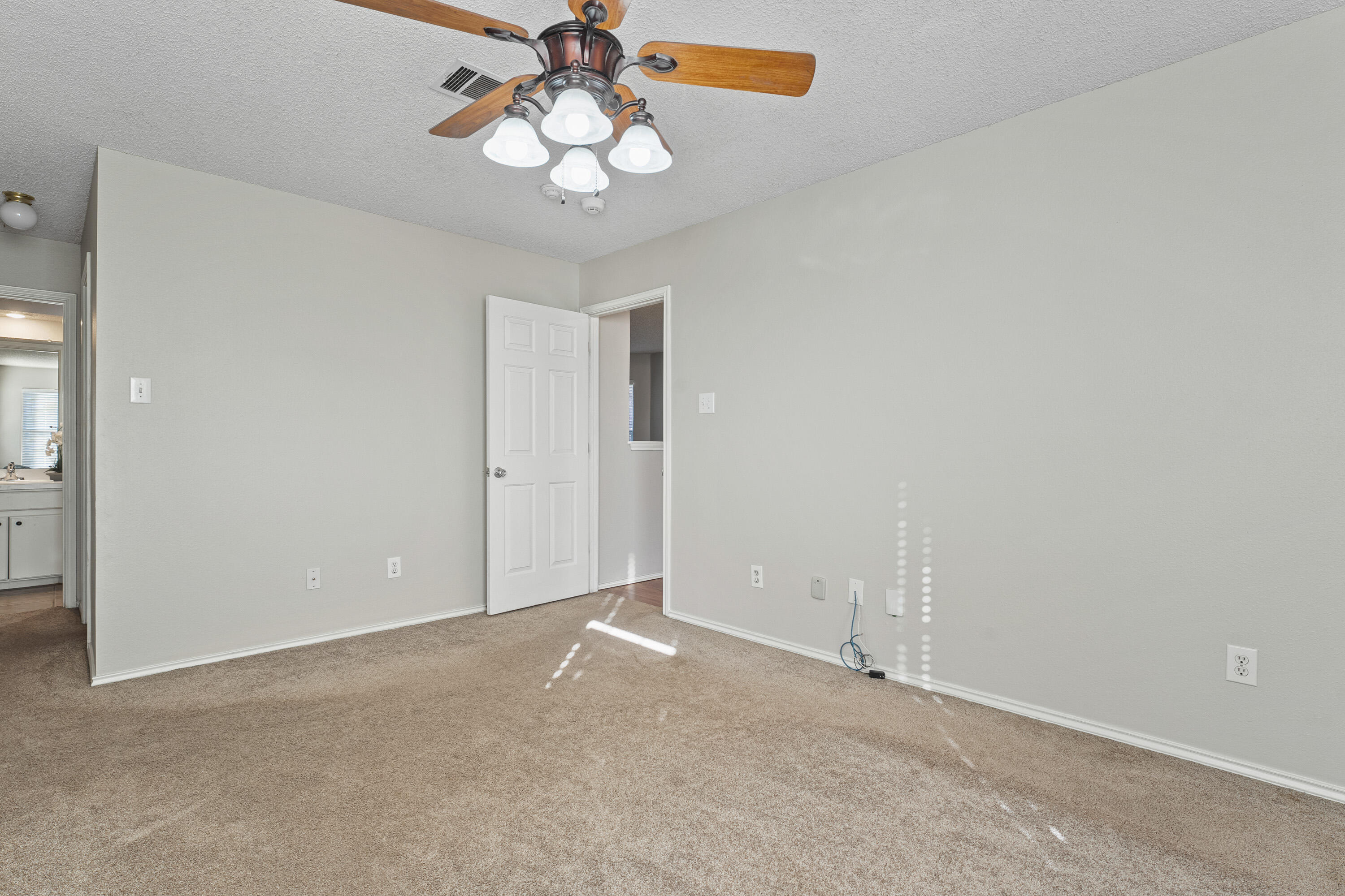 1701 79th Street Lubbock, TX 79423 - Photo 15 of 26 a view of an empty room with a chandelier fan