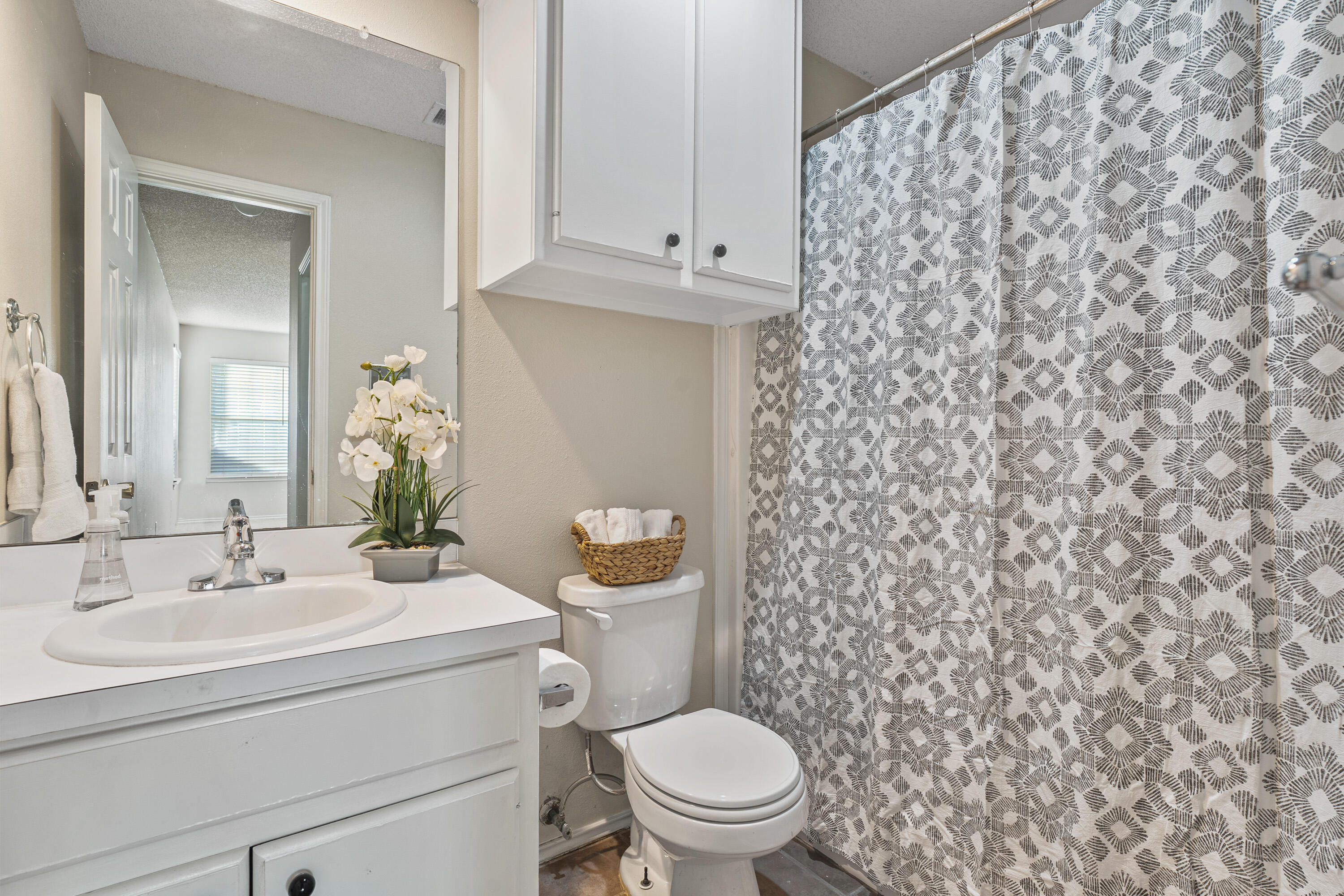 1701 79th Street Lubbock, TX 79423 - Photo 17 of 26 a bathroom with a sink toilet and mirror