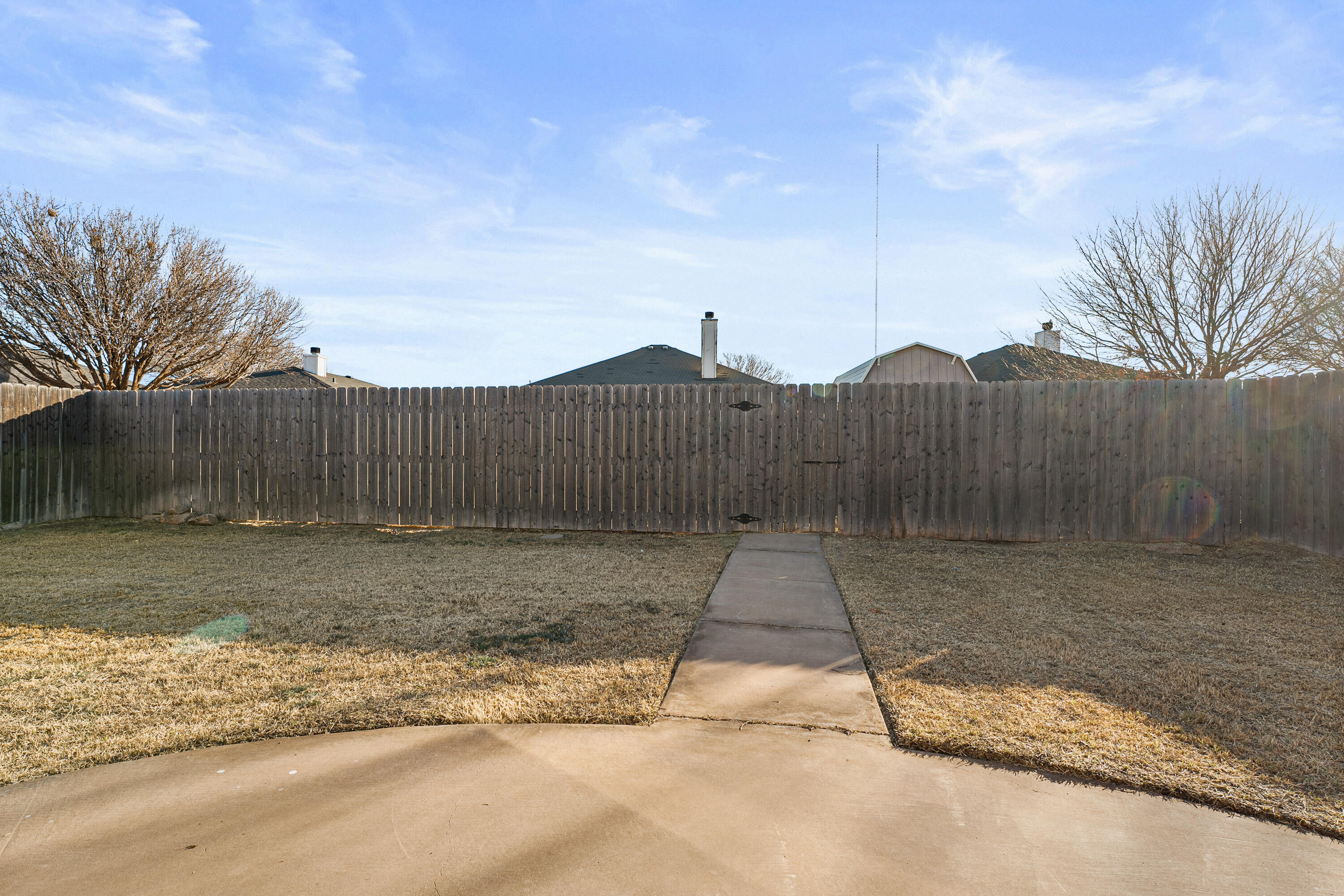 1701 79th Street Lubbock, TX 79423 - Photo 23 of 26 a view of a yard with wooden fence