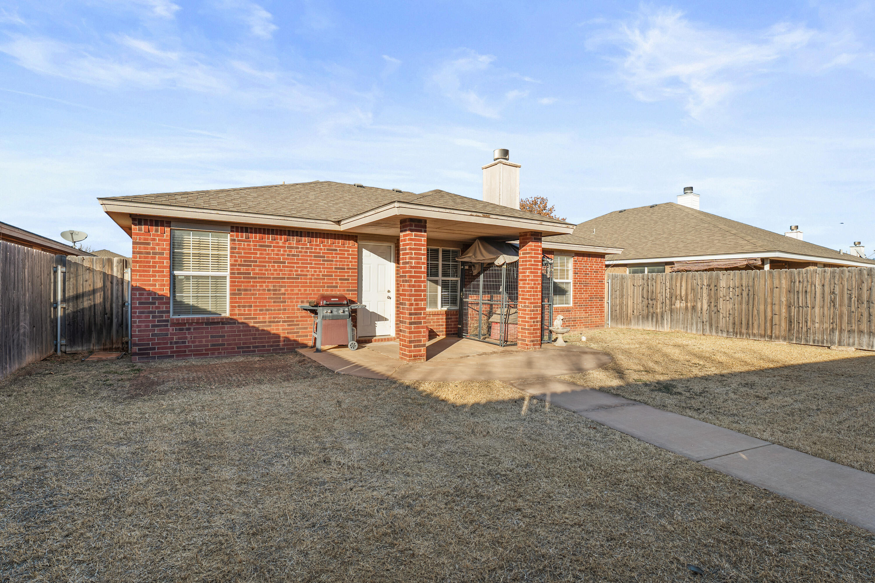 1701 79th Street Lubbock, TX 79423 - Photo 25 of 26 a front view of a house with a yard