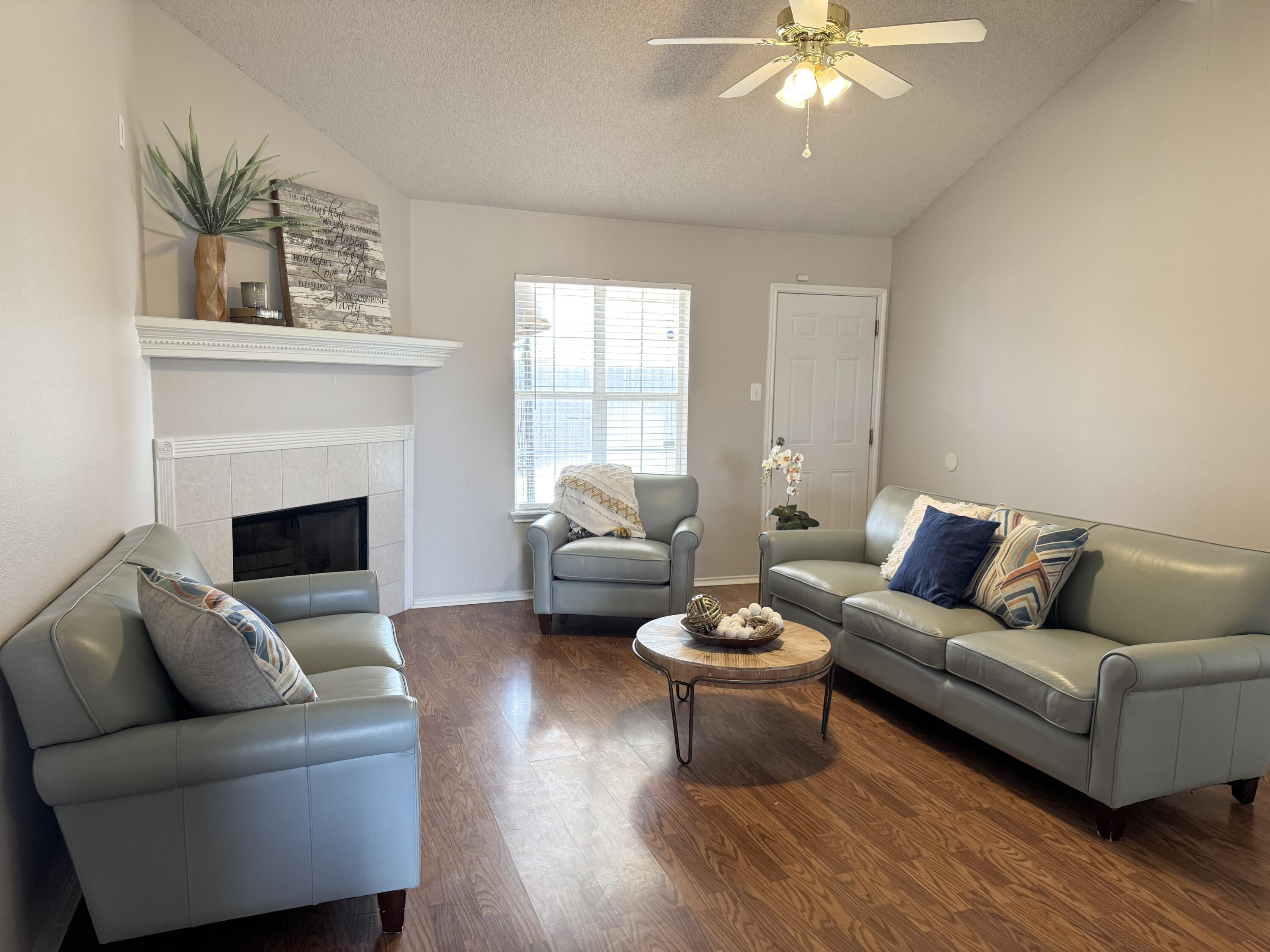 1701 79th Street Lubbock, TX 79423 - Photo 5 of 26 a living room with furniture and a fireplace