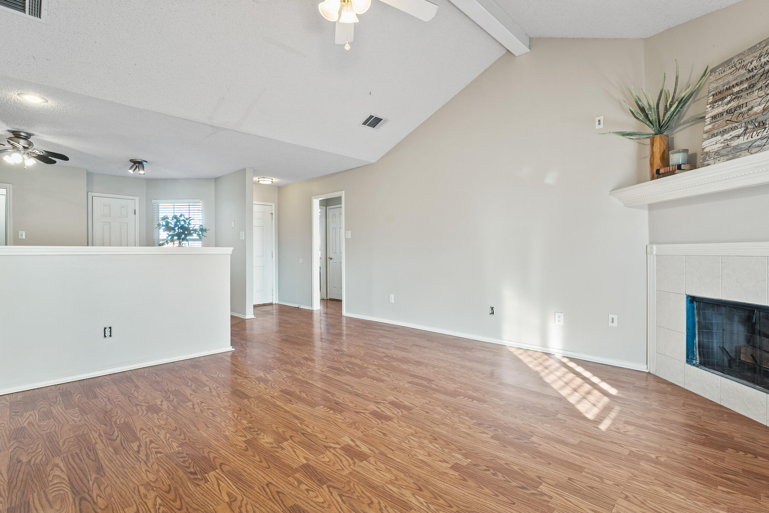 1701 79th Street Lubbock, TX 79423 - Photo 7 of 26 a view of empty room with wooden floor and fireplace