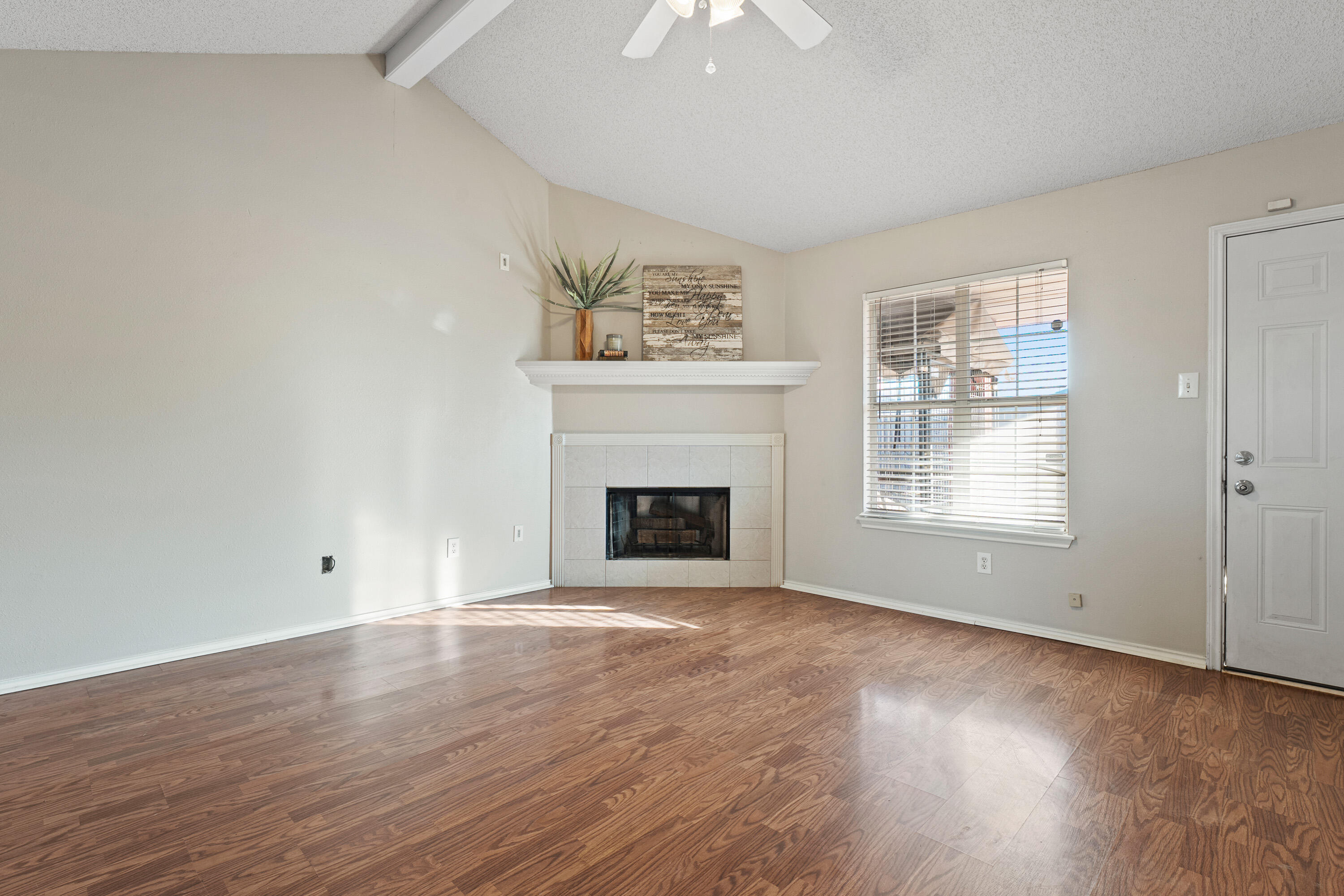 1701 79th Street Lubbock, TX 79423 - Photo 8 of 26 wooden floor fireplace and windows in an empty room
