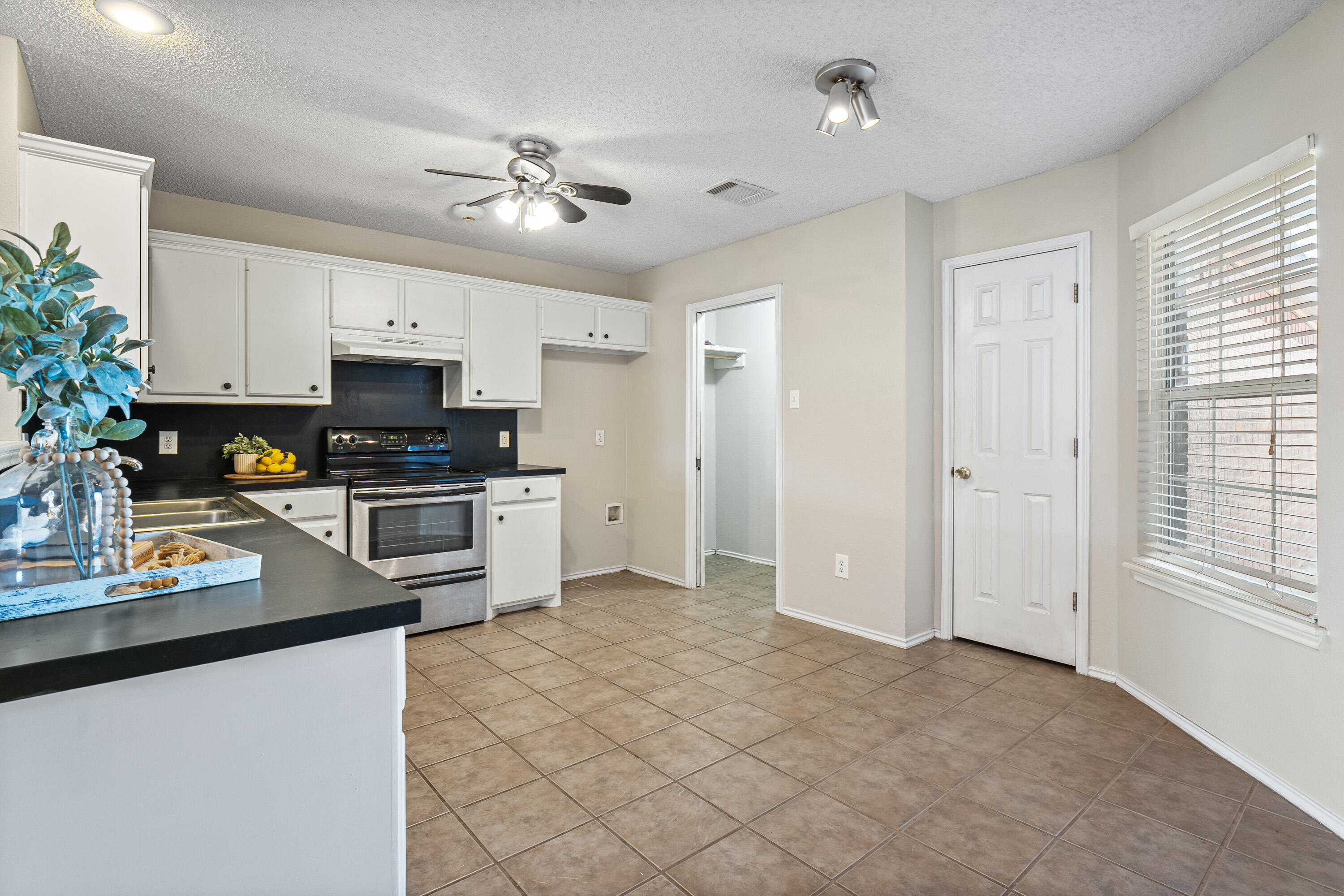 1701 79th Street Lubbock, TX 79423 - Photo 9 of 26 a kitchen with kitchen island a counter top space appliances and cabinets