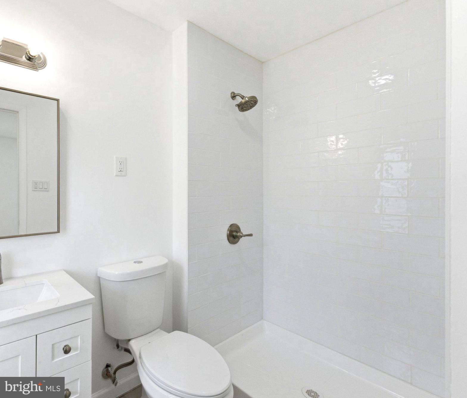 49 Middleton Lane Willingboro, NJ 08046 - Photo 14 of 23 a white toilet sitting next to a bath tub