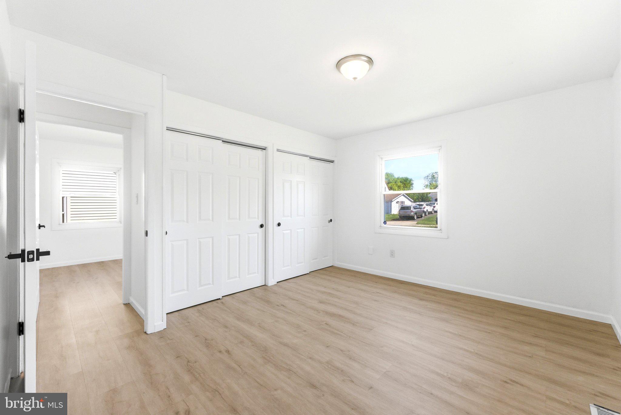 49 Middleton Lane Willingboro, NJ 08046 - Photo 15 of 23 an empty room with wooden floor and windows