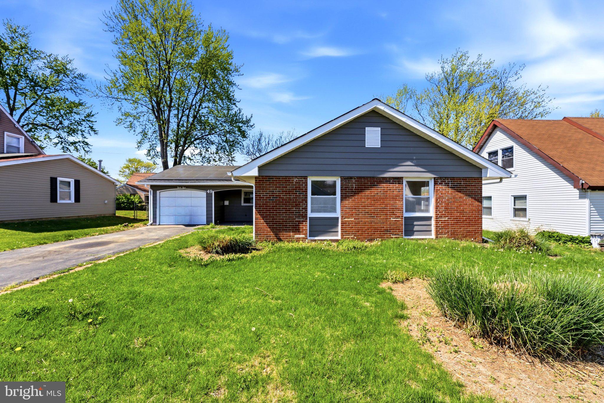 49 Middleton Lane Willingboro, NJ 08046 - Photo 2 of 23 a front view of a house with a garden and yard
