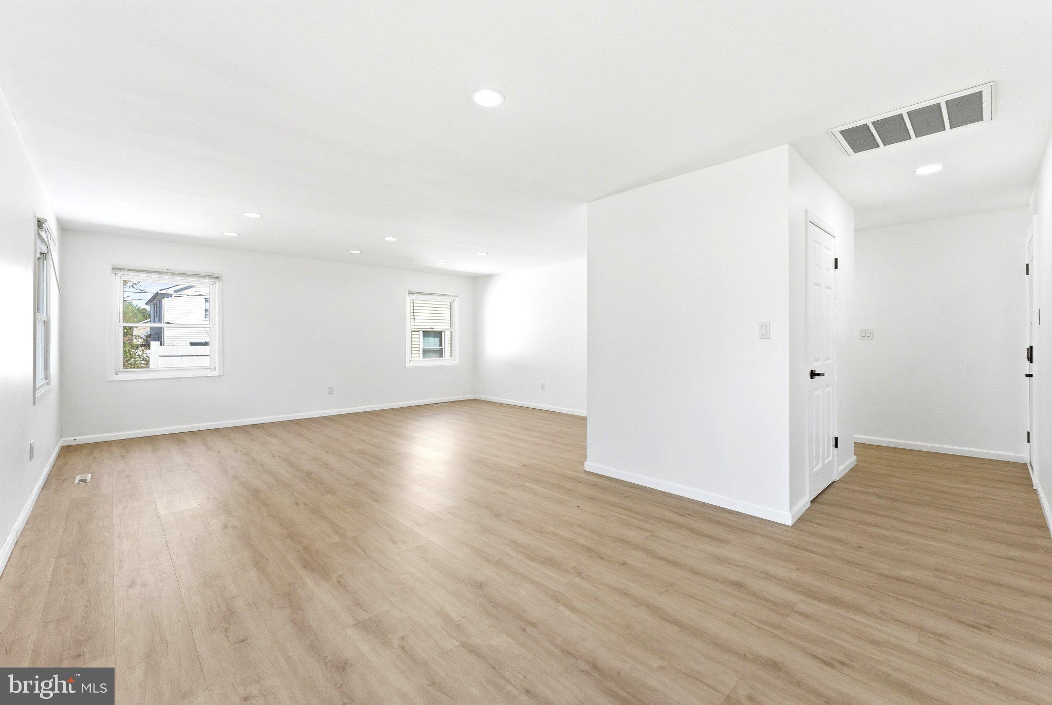 49 Middleton Lane Willingboro, NJ 08046 - Photo 5 of 23 an empty room with wooden floor and windows