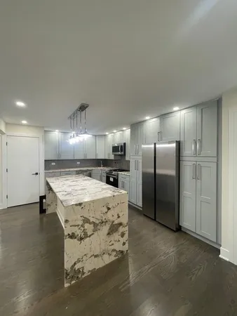 a large kitchen with cabinets and stainless steel appliances