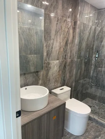 a bathroom with a toilet sink and shower