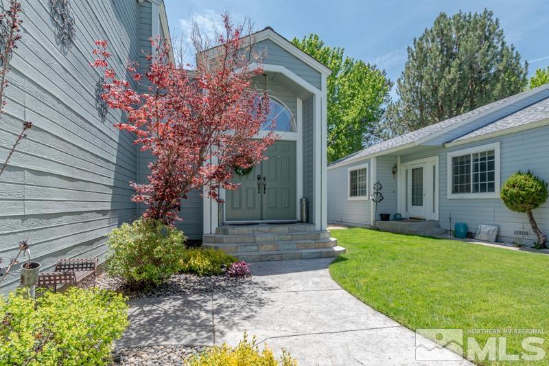 7575 Lighthouse Lane Reno, NV 89511 - Photo 3 of 40 a front view of a house with garden