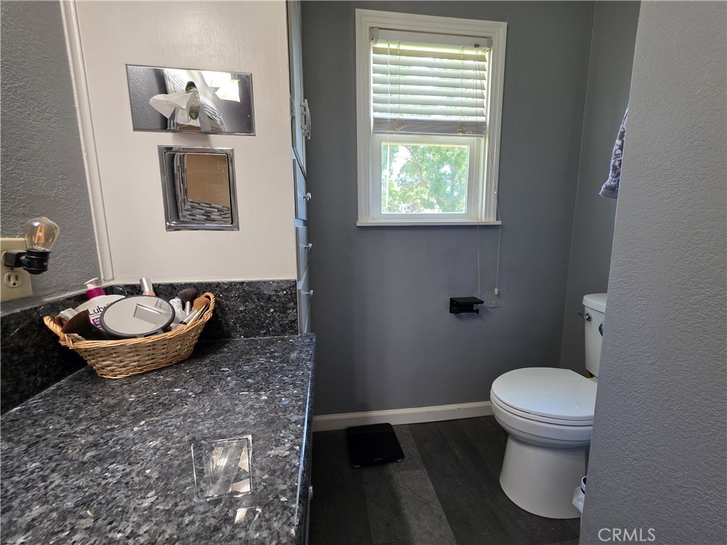 23773 River Road Corning, CA 96021 - Photo 22 of 64 a bathroom with a toilet and a mirror