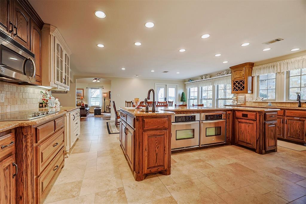 222 Bayne Road Haslet, TX 76052 - Photo 14 of 40 kitchen with large center island, double ovens, and natural light